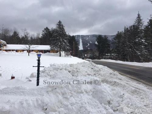 a pile of snow on the side of a road at Snowdon Chalet Motel in Londonderry