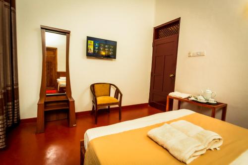 Una cama o camas en una habitación de Dayanithi Guest House