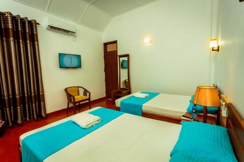 Postel nebo postele na pokoji v ubytování Dayanithi Guest House