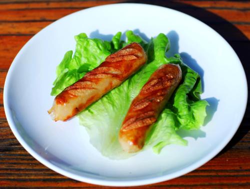two pieces of food on a white plate with lettuce at Yangshuo Coco Garden Hotel in Yangshuo