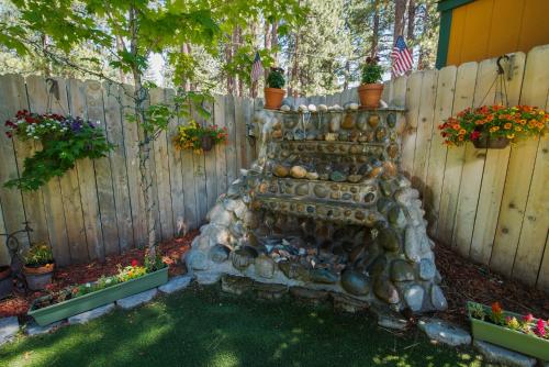 a stone wall in a garden next to a fence at Fireside Lodge in South Lake Tahoe