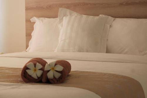 a bed with two donuts on top of it at Wika Bali Beach House in Jimbaran