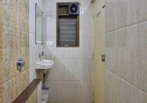 a bathroom with a sink and a mirror at Hotel Krushna Inn in Trimbak