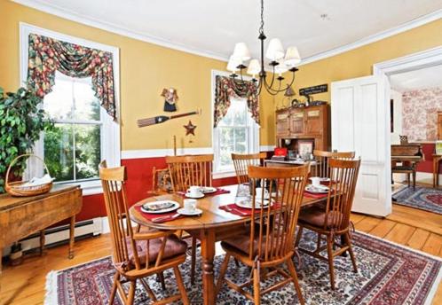 a kitchen and dining room with a table and chairs at Black Lantern B&B in Topsham