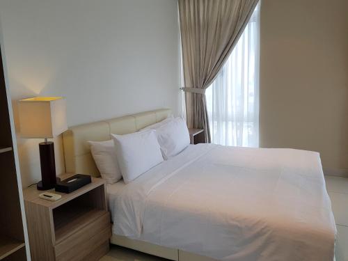 a bedroom with a white bed and a window at KSL Hotel & Resort in Johor Bahru