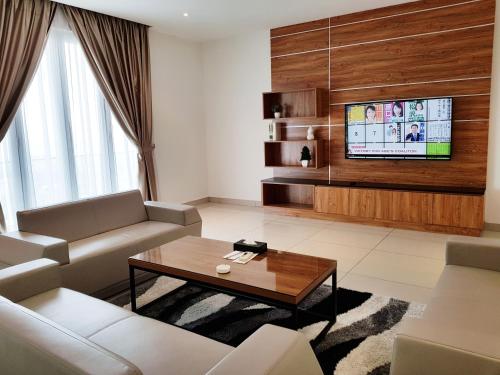 a living room with a couch and a tv at KSL Hotel & Resort in Johor Bahru