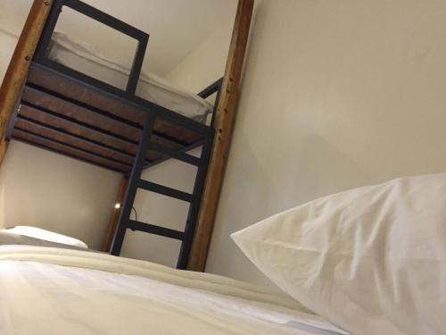 a bedroom with two bunk beds and a pillow at Kuree Hut in Semporna
