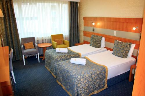 Postel nebo postele na pokoji v ubytování Burcman Hotel