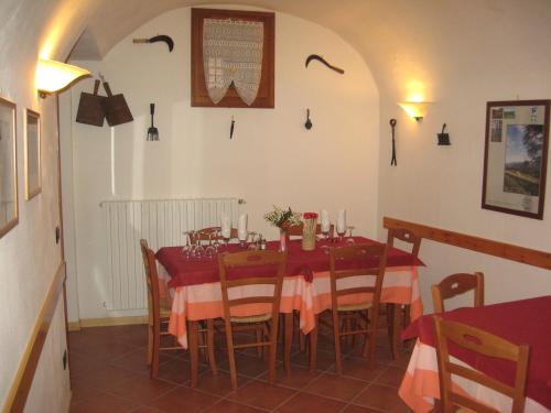 a dining room with a red table and chairs at Antica Osteria Pace in Moerna