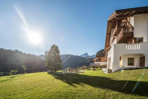 a large grassy field next to a building at Apartments Tino in La Valle
