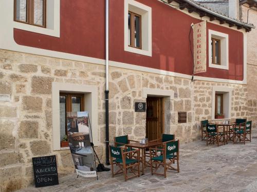 a table and chairs outside of a building at aCienLeguas in Castrojeriz
