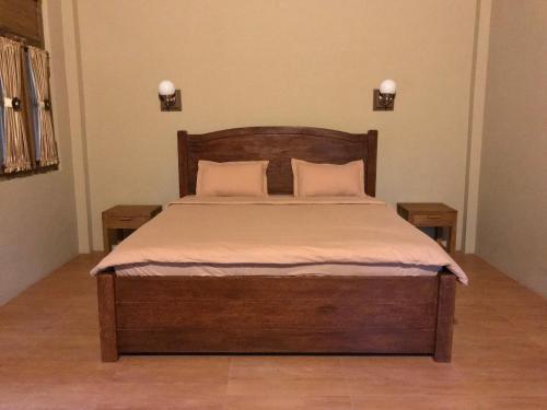 a bed with two pillows on it in a bedroom at Rumah Dharma 2 Riverside in Borobudur