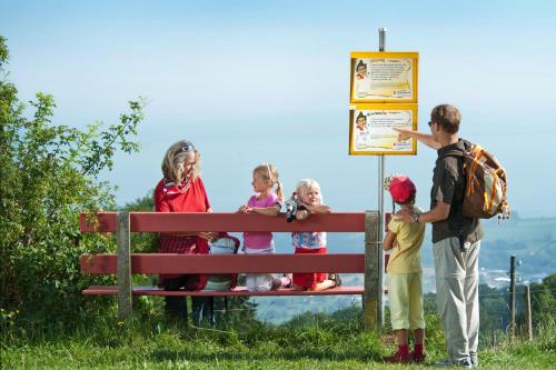 a group of children standing on a park bench at Hotel Landhaus Säntis Herisau in Herisau