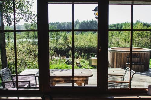 a view from a window of a patio with a table and chairs at Dabintos slėnis in Sumiliszki