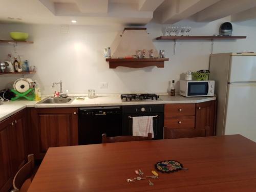a kitchen with a wooden table and a refrigerator at ai Templari San Marco in Venice