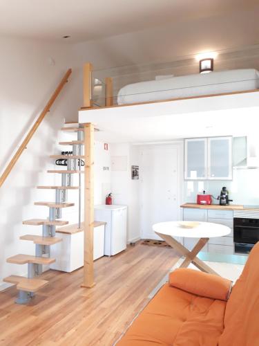 a living room with a spiral staircase in a tiny house at Vila Madre Deus II in Lisbon