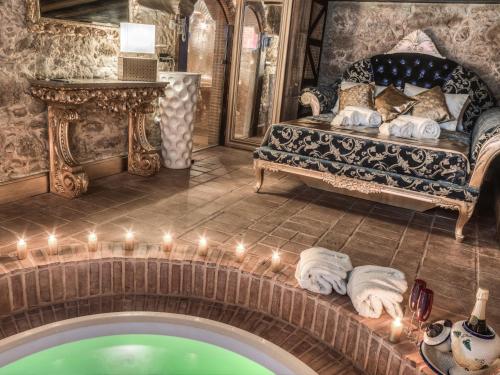 a room with a couch and a swimming pool at Solar Antigo Luxury Spa Coimbra in Coimbra