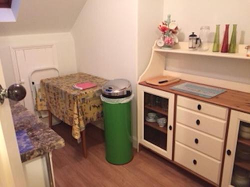 a small kitchen with a table and a trash can at Southfield House in Hornsea