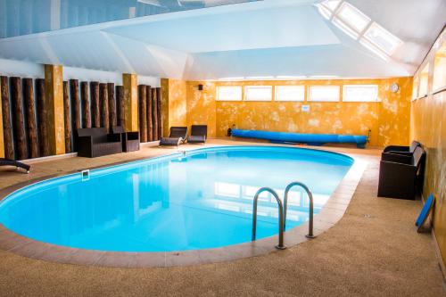 a large swimming pool in a hotel room at Hotel Kamei in Snina