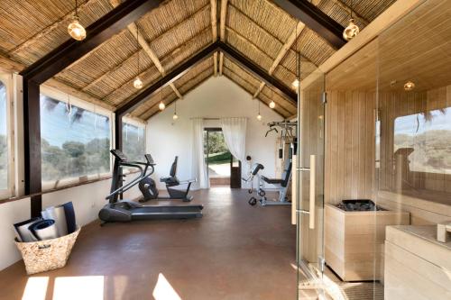 a gym with exercise equipment in a house at Stazzo Lu Ciaccaru in Arzachena