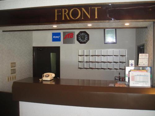 a front desk of a store with a phone at Hakuba Park Hotel in Hakuba