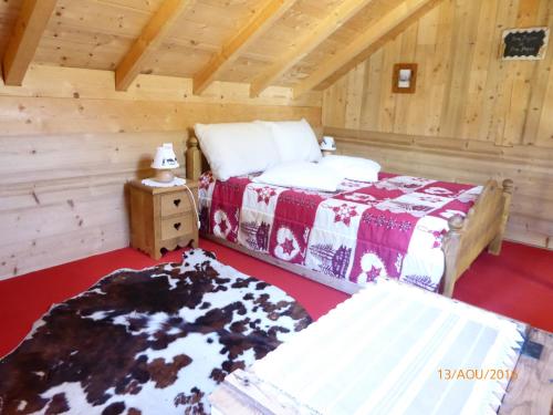 サン・ジャン・ドルプにあるChalet Fleur des Neigesのログキャビン内のベッドルーム1室(ベッド2台付)