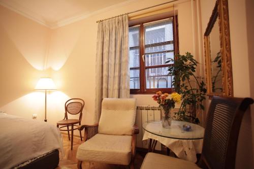 una camera da letto con un letto, un tavolo e una sedia di Studio Hram a Belgrado