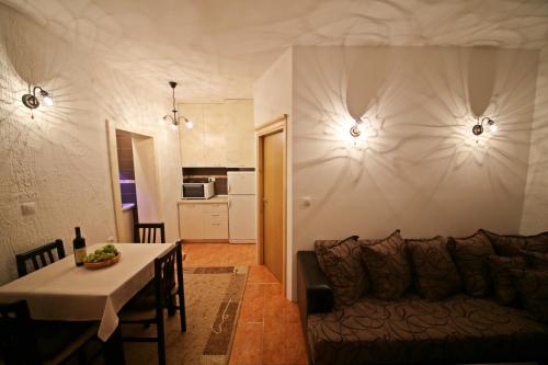 a living room and kitchen with a couch and a table at Apartman Vanja in Bar