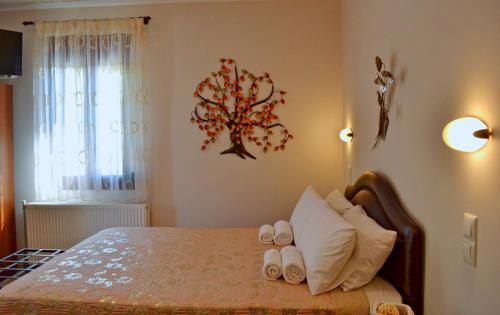 a bedroom with a bed with white towels on it at Anesis in Ioannina