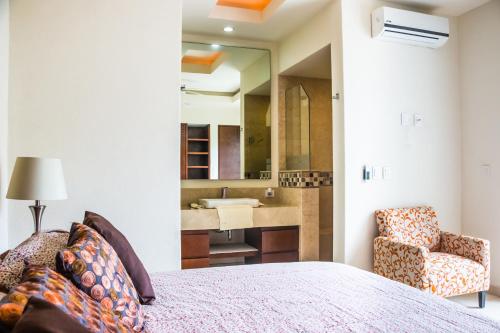 a bedroom with a bed and a bathroom with a sink at V399 - 307 in Puerto Vallarta