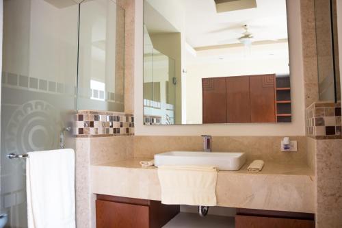 a bathroom with a sink and a large mirror at V399 - 307 in Puerto Vallarta