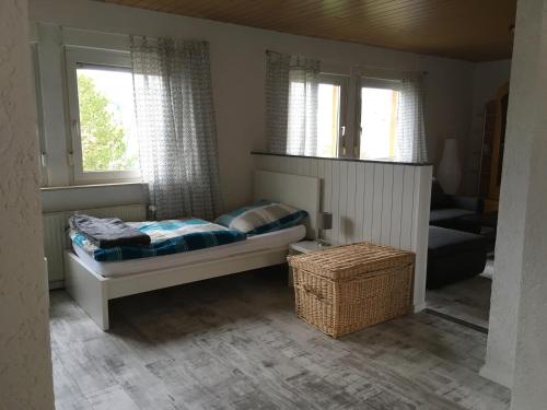 a small bedroom with a bed and two windows at KRIO Nicola Rothfuchs Ferienwohnung 1 in Idar-Oberstein