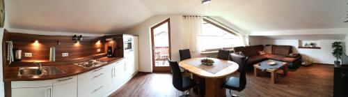 a kitchen and living room with a couch and a table at Ferienwohnung Traudl in Inzell