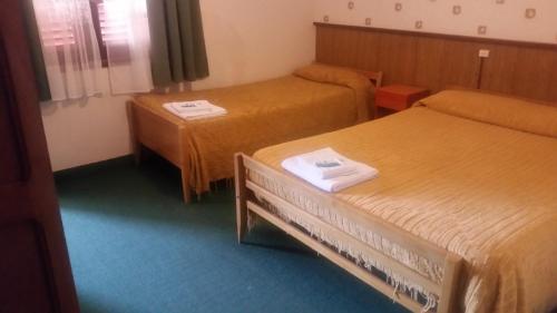 a hotel room with two beds and two tables at Palace Hotel in Miramar