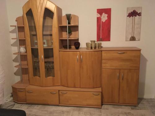 a wooden cabinet in a room at KRIO Nicola Rothfuchs Ferienwohnung 1 in Idar-Oberstein