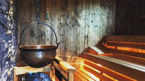 a metal bucket hanging from a wall in a room at Hotel Alpenhof in Bad Wörishofen