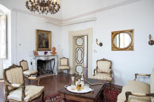 a living room with a table and chairs and a fireplace at Castello di Casamassella - Marea Stays Collection in Casamassella