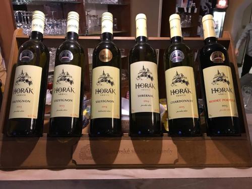 a bunch of bottles of wine on a shelf at Rybářská restaurace a penzion u Horáků in Uničov