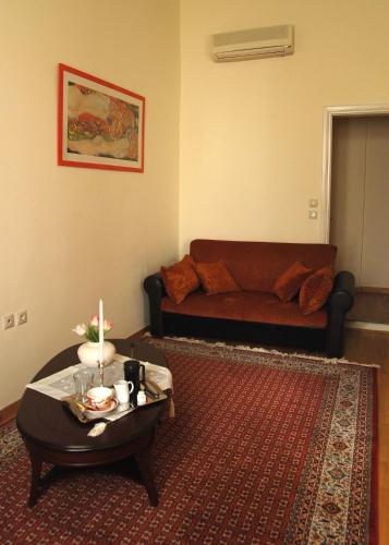 a living room with a couch and a coffee table at Allotino Pension in Nafplio