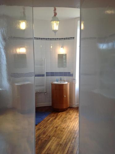 a bathroom with a sink and a mirror at Château de La Ville-Huë in Guer