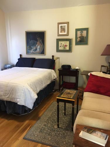 a bedroom with a bed and a couch and a table at SWEET Suite BAKER Street in San Francisco