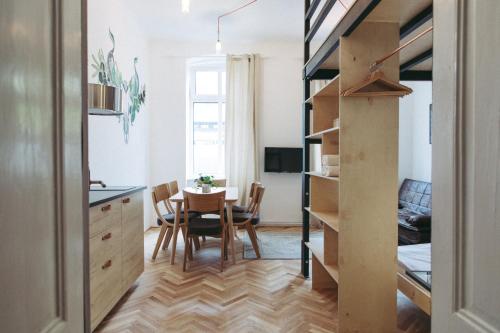 a small kitchen and dining room with a table and chairs at Boutique Apartments Possonium in Bratislava