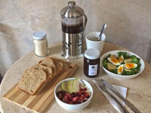een tafel met een bord brood en een fruitschaal bij La Flor Casa Boutique in Valladolid