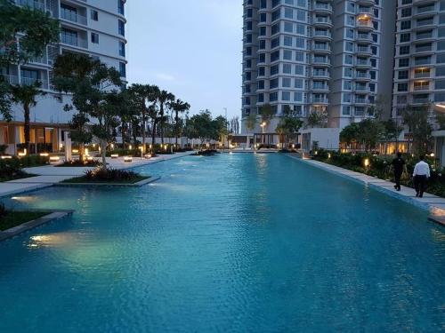 a blue river in a city with tall buildings at Seaview high floor teega suite at puteri harbour in Nusajaya