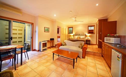 a living room with a couch and a table at Eden House Retreat in Yungaburra