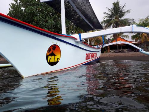 a boat that is sitting in the water at Gede Homestay in Lovina