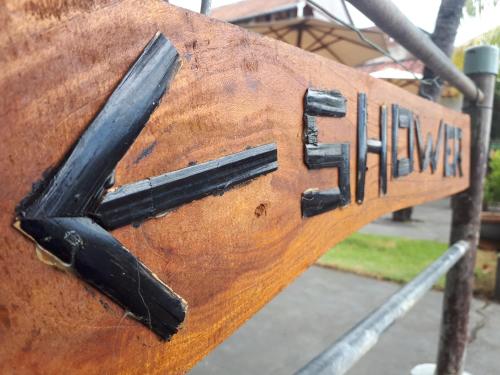 a wooden sign that reads the end of a bench at Gede Homestay in Lovina