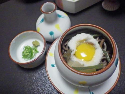 a bowl of food with an egg on a plate at Kosenkaku Yoshinoya in Totsukawa
