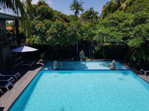 a swimming pool with two animals in the water at Sanur Agung Hotel in Sanur