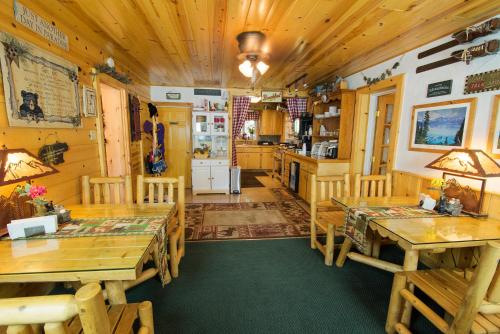 a dining room with wooden tables and a kitchen at Fireside Lodge in South Lake Tahoe